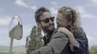 Young couple on scooter kissing