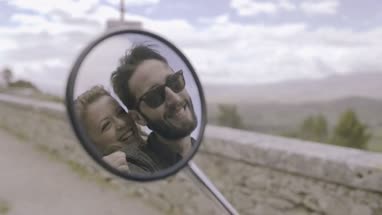Reflection in side mirror of couple kissing