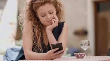 Young adult female messaging in cafe