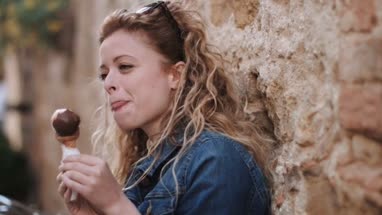 Young adult female eating gelato