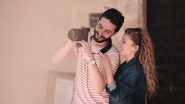 Young tourists using DSLR on vacation