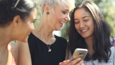 Young female friends socialising outdoors