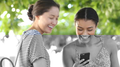 Young female friends socialising outdoors