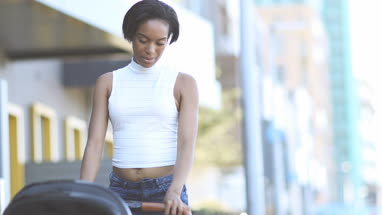 Afro-american mother walking with stroller