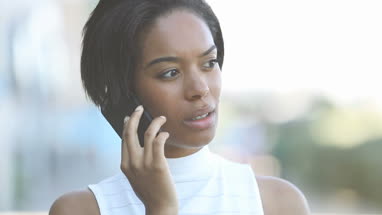 Afro american using smartphone outdoors