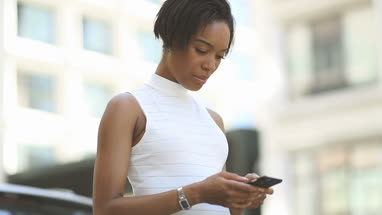 Afro american using smartphone outdoors