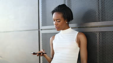 Afro american using smartphone outdoors