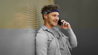 Portrait trendy male using smartphone