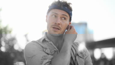 Trendy male listening to music in city