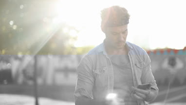 Trendy male listening to music in city