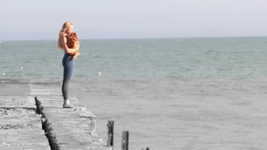 Young female on beach with pet dog