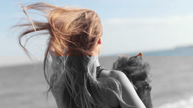 Young female on beach with pet dog