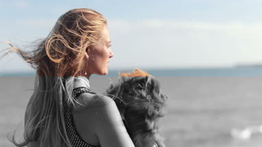 Young female on beach with pet dog