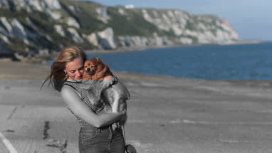 Young female on beach with pet dog