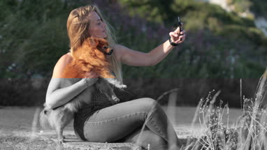 Young adult female taking selfie with dog