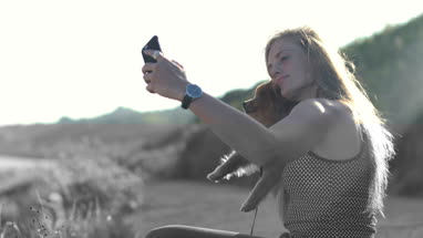Young adult female taking selfie with dog