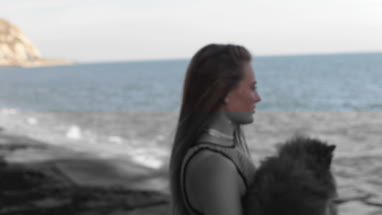 Young female on beach with pet dog