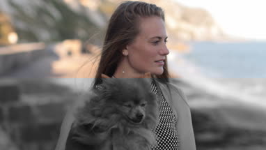 Young female on beach with pet dog