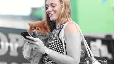 Young female with pet dog and smartphone