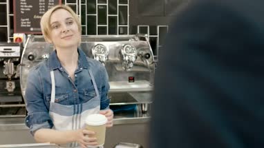 Barista serving business man in cafe