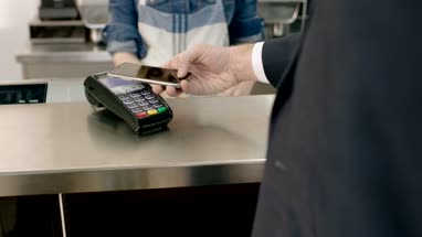 Business man paying contactless in cafe
