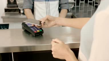 Business woman paying contactless in cafe