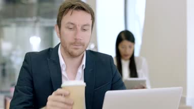 Entrepreneur working on laptop in cafe