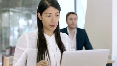 Entrepreneur working on laptop in cafe