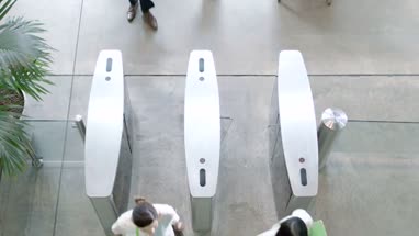 Business people entering office trough security gates