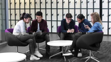 Students all using personal technology in college