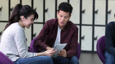 Students sharing digital tablet