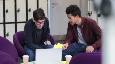 Male students working on a project together