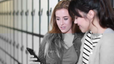 Female students looking at smartphone