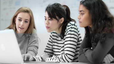 Female students looking at laptop