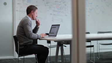Businessman in meeting room working on presentation