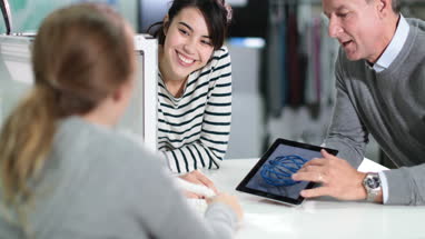 Students discussing 3D printer with teacher