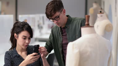Fashion students taking picture of a design with smartphone