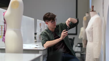Fashion student taking picture of a design with smartphone