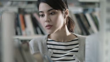 Student reading in a library