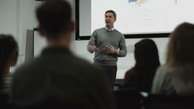 Professor teaching with projector