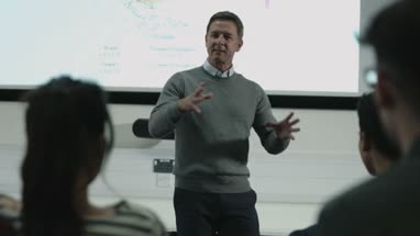 Professor teaching with projector