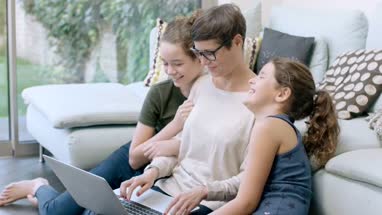 Mom with daughters using laptop together