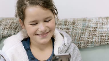 Child using smartphone at home