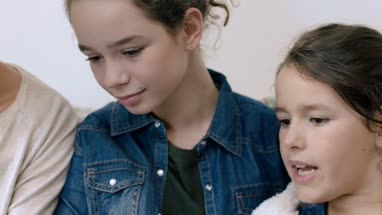 Daughters showing mom digital tablet