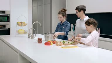 Mom teaching kids to cook a meal