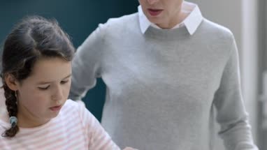 Mom teaching daughter to cook a meal