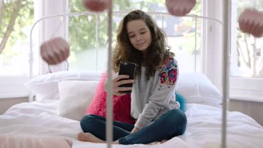 Teenager posing for selfie in bedroom