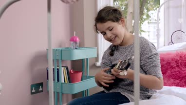 Girl playing ukulele and singing in her room