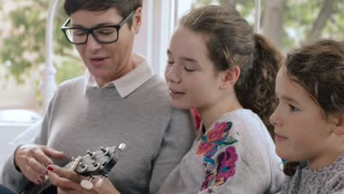 Mom playing ukulele to kids