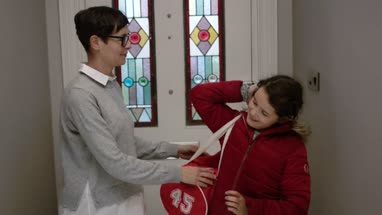 Mom saying goodbye to daughter at the door